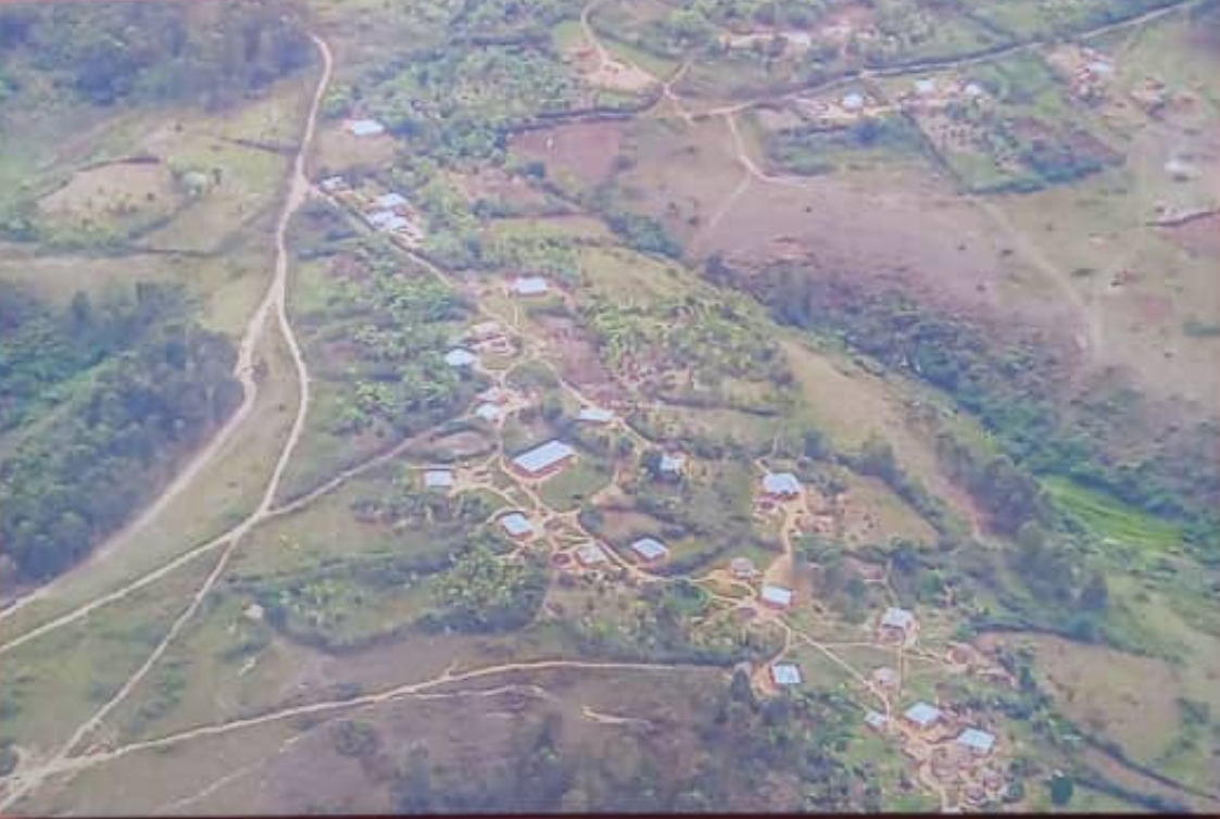 Aerial view of rural homes, farmland and green hills 1